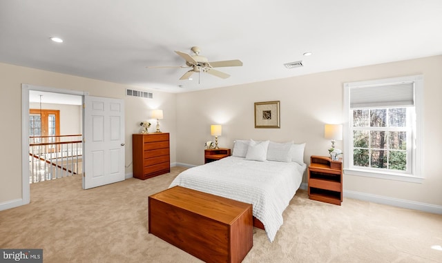 bedroom with light carpet, recessed lighting, visible vents, and baseboards