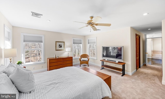 bedroom with baseboards, multiple windows, visible vents, and light colored carpet