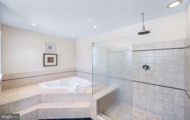 bathroom featuring a walk in shower, a bath, and recessed lighting