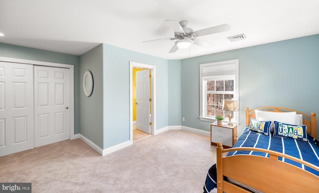 bedroom with baseboards, a closet, visible vents, and carpet flooring