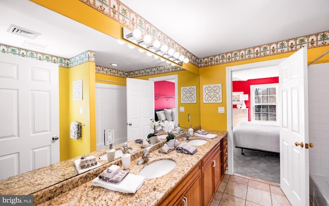 full bathroom featuring double vanity, visible vents, a sink, and ensuite bathroom