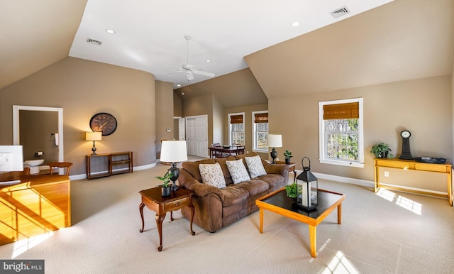 carpeted living area featuring lofted ceiling, baseboards, visible vents, and a ceiling fan