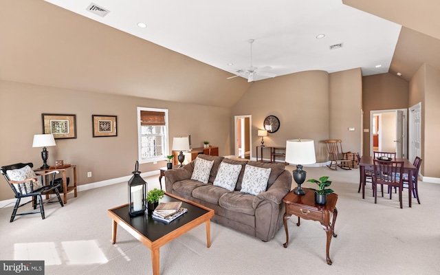 living area with lofted ceiling, ceiling fan, visible vents, and light colored carpet