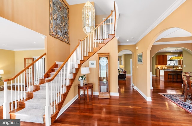 stairs featuring recessed lighting, crown molding, hardwood / wood-style floors, and baseboards