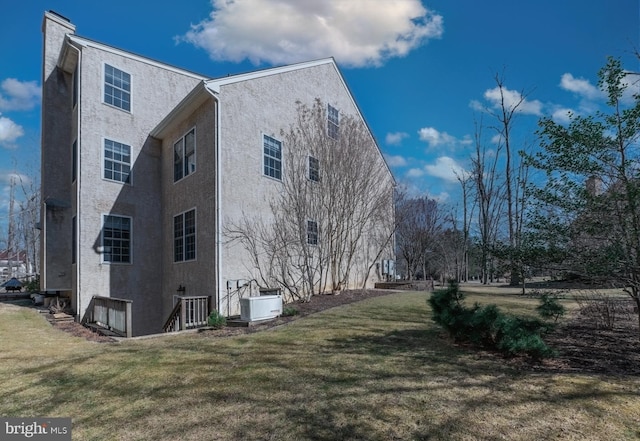 view of property exterior featuring a yard and stucco siding