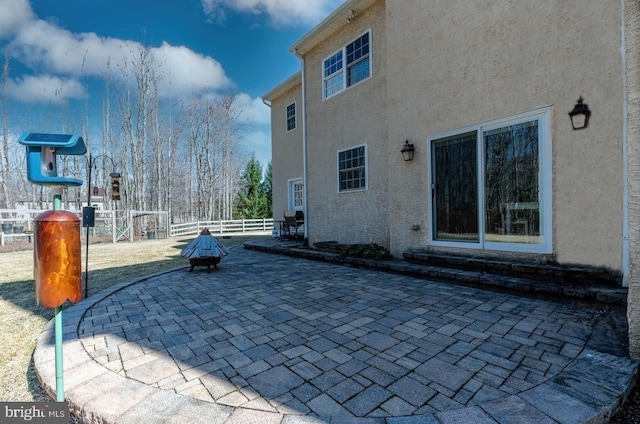 view of patio featuring fence and a playground