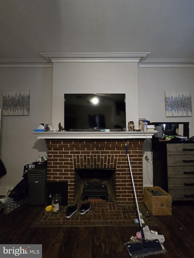 details featuring a brick fireplace, crown molding, and hardwood / wood-style floors