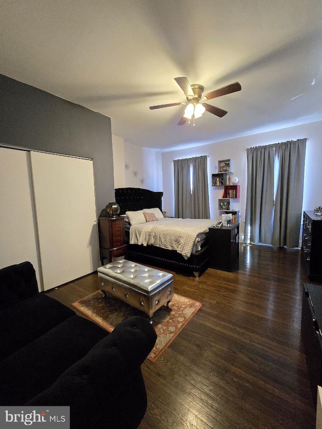 bedroom with dark hardwood / wood-style flooring and ceiling fan