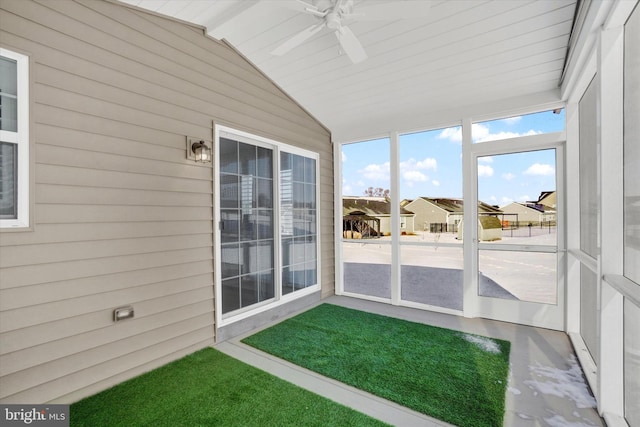 unfurnished sunroom featuring ceiling fan and lofted ceiling