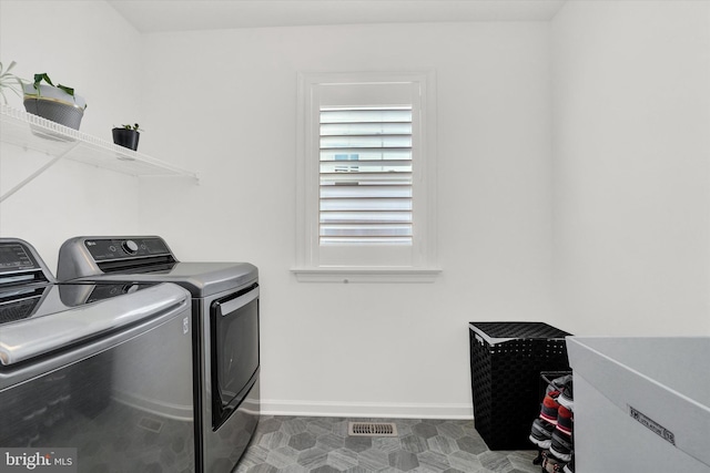 clothes washing area with independent washer and dryer