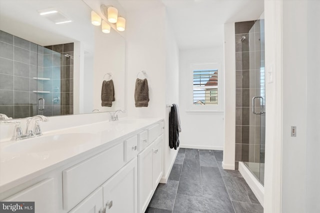 bathroom with vanity and a shower with shower door