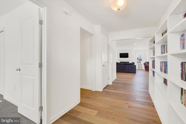 hallway with light hardwood / wood-style flooring