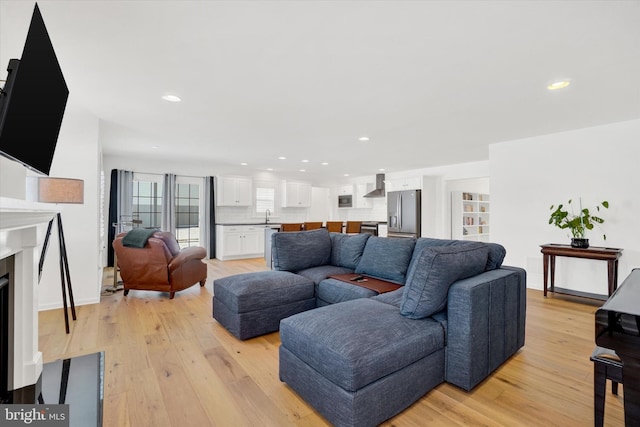 living room with sink and light hardwood / wood-style floors