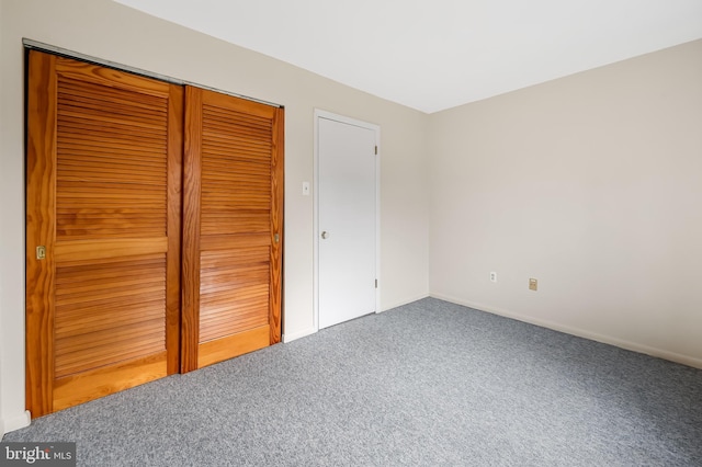 unfurnished bedroom with carpet floors and a closet