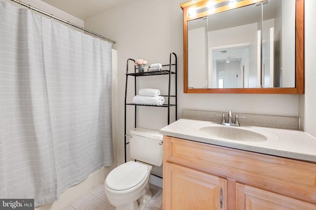 bathroom with vanity, walk in shower, tile patterned floors, and toilet