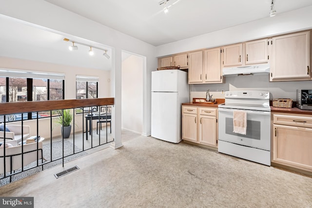 kitchen featuring track lighting, light brown cabinetry, and white appliances