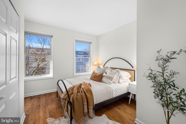 bedroom with dark hardwood / wood-style floors