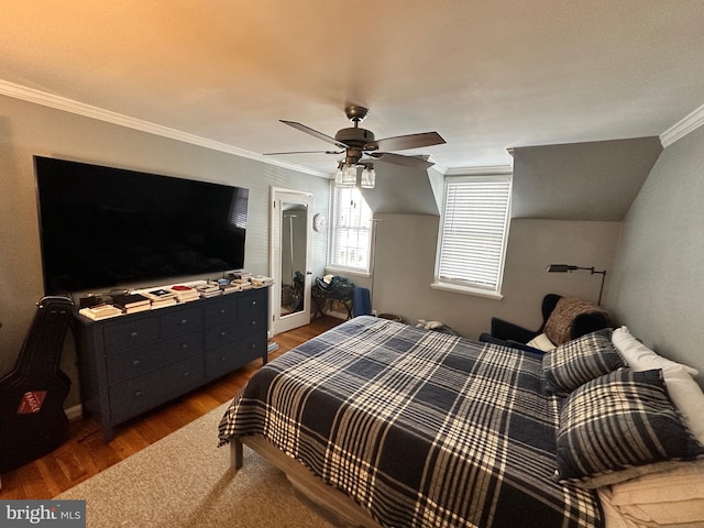 bedroom with ornamental molding, dark hardwood / wood-style floors, and ceiling fan