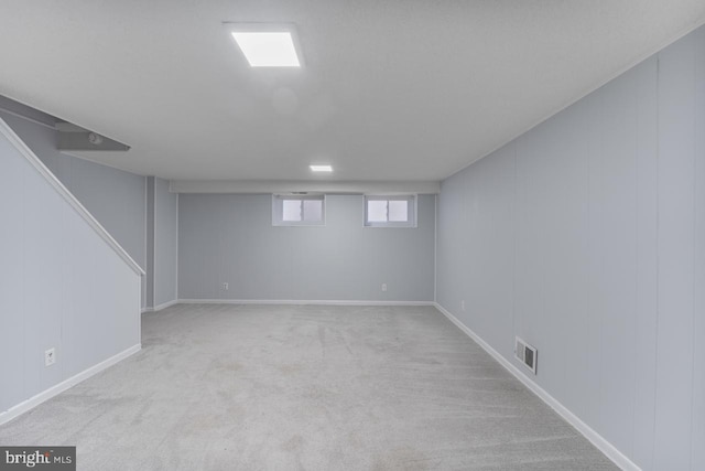 basement featuring light carpet