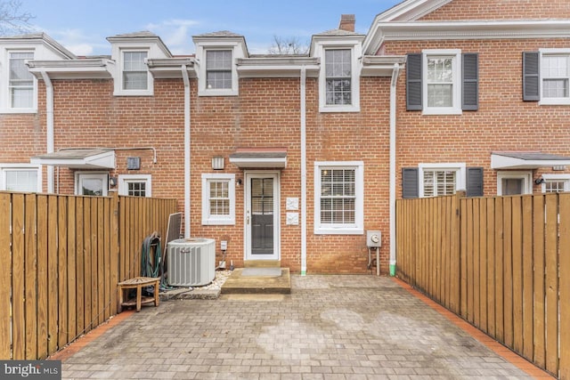 rear view of house featuring a patio and central air condition unit