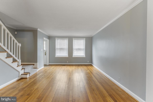 interior space with ornamental molding and light wood-type flooring