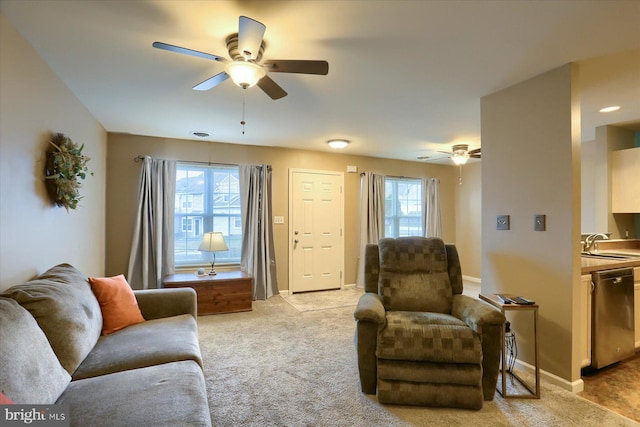 carpeted living room with sink and ceiling fan