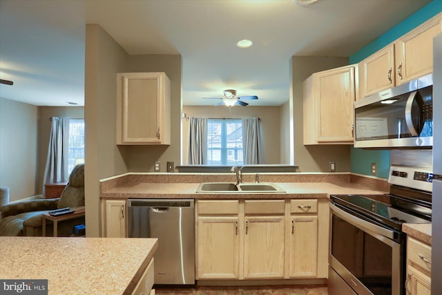 kitchen with ceiling fan, appliances with stainless steel finishes, and sink