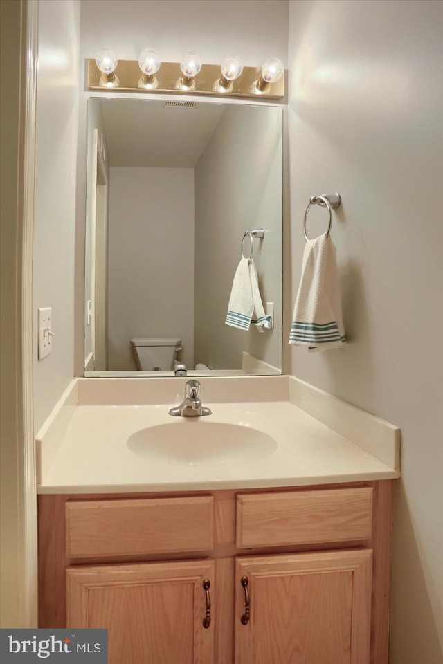 bathroom with vanity and toilet