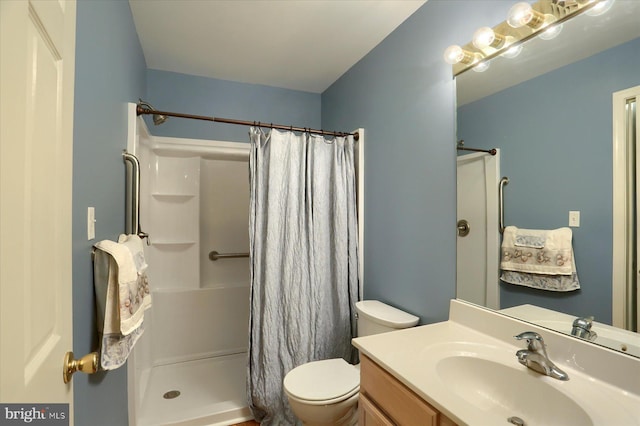 bathroom with vanity, toilet, and curtained shower