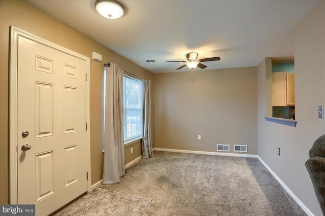 interior space with ceiling fan