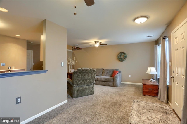 carpeted living room with ceiling fan