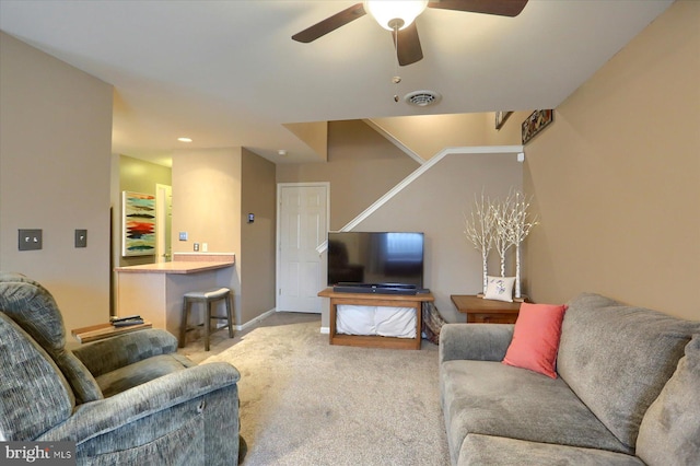 carpeted living room with ceiling fan