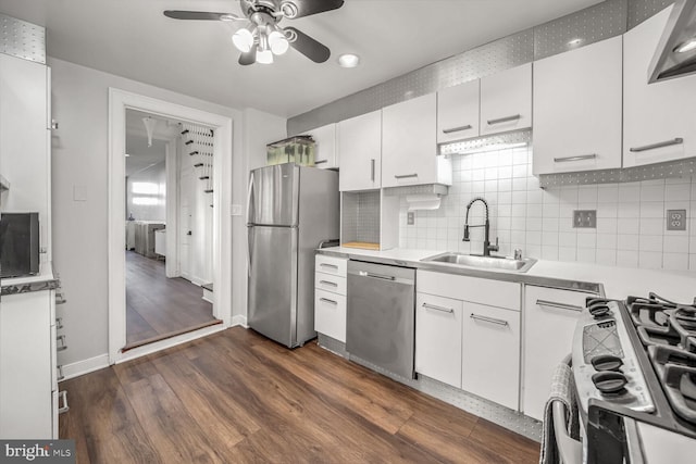 kitchen with sink, white cabinets, dark hardwood / wood-style flooring, and stainless steel appliances