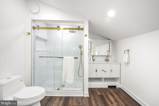 bathroom with vanity, hardwood / wood-style flooring, an enclosed shower, and lofted ceiling