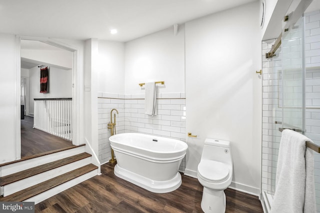 bathroom with hardwood / wood-style flooring, toilet, and independent shower and bath