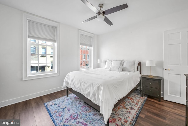 bedroom with dark hardwood / wood-style floors and ceiling fan