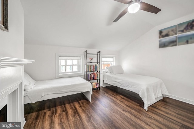 bedroom with ceiling fan, vaulted ceiling, and hardwood / wood-style flooring