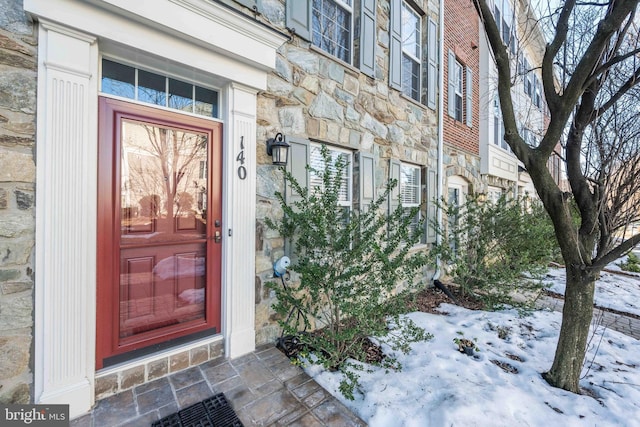 view of snow covered property entrance