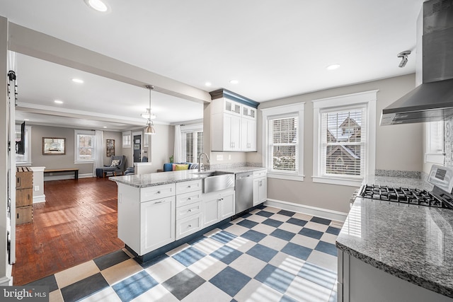 kitchen with white cabinetry, dishwasher, and kitchen peninsula