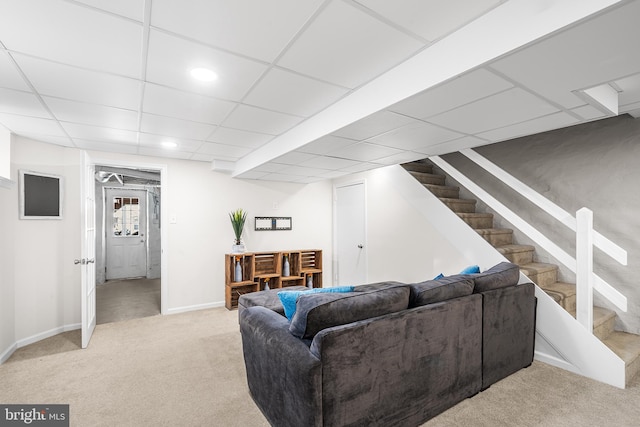 living room with light colored carpet and a drop ceiling