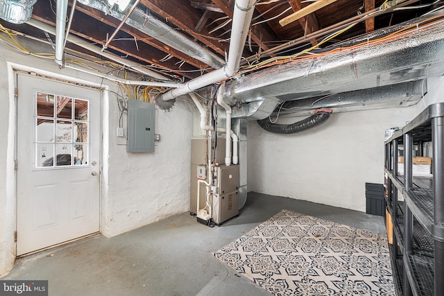 basement featuring heating unit and electric panel