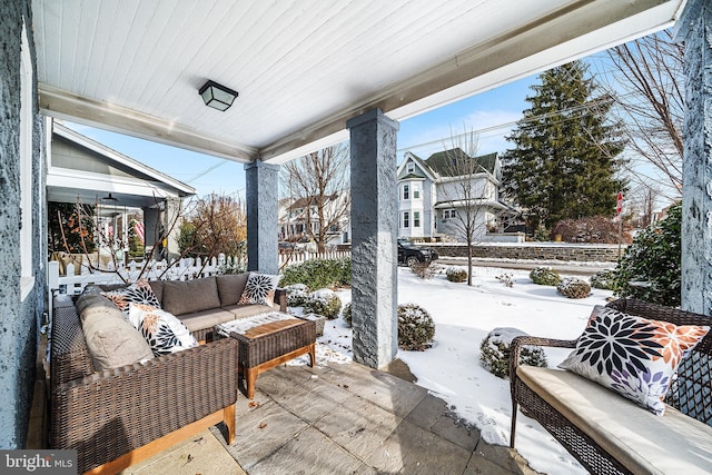 snow covered patio featuring outdoor lounge area