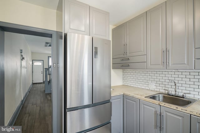 kitchen with sink, gray cabinetry, and stainless steel fridge