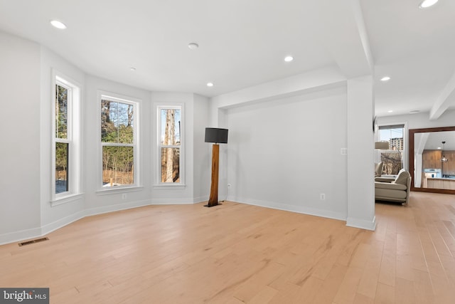 empty room with light hardwood / wood-style flooring