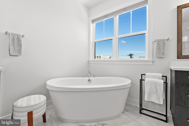 bathroom featuring vanity and a washtub