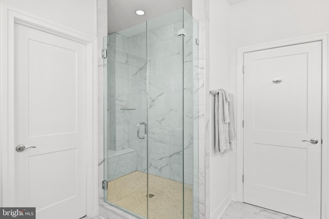 bathroom with a shower with shower door