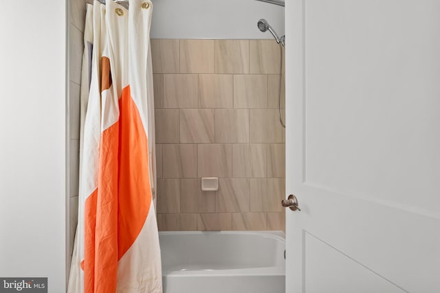 bathroom with shower / bathtub combination with curtain