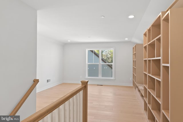 interior space with lofted ceiling and light wood-type flooring