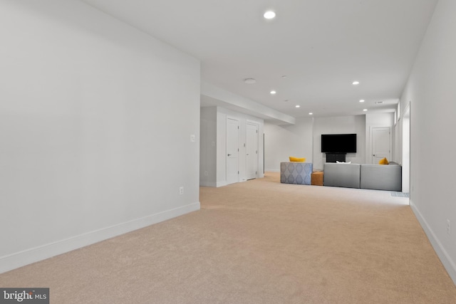 unfurnished living room with light colored carpet