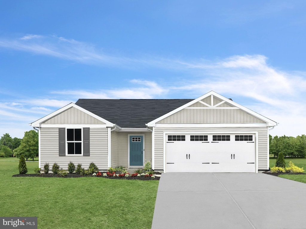 view of front of house featuring a front yard and a garage